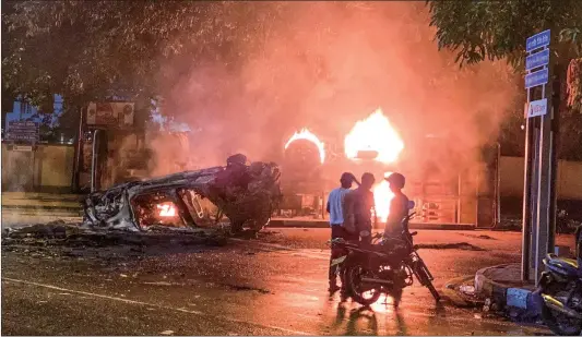  ?? Photo: VCG ?? A vehicle belonging to the security personnel and a bus set alight are pictured near Sri Lanka’s outgoing Prime Minister Mahinda Rajapaksa’s official residence in Colombo, Sri Lanka on May 9, 2022.