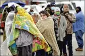  ?? David J. Phillip Associated Press ?? PEOPLE line up for propane in Houston on Feb. 17 as cold weather halted natural gas service.