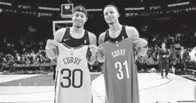  ?? STEVE DYKES/ASSOCIATED PRESS ?? Trail Blazers guard Seth Curry, left, and his brother, Warriors guard Stephen Curry, exchange jerseys after a game. The pair competed in Saturday night’s 3-point contest.