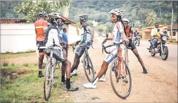  ??  ?? Members of Bangui’s cycling team wait prior to taking part in a weekly training session. — AFP photo