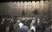  ?? MAHMOUD ILLEAN AP ?? Muslim men carry the body of Iyad Halak for burial Sunday. Israeli police shot him dead in Jerusalem’s old city Saturday as the autisic man was walking to a special needs school.