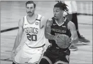  ?? MIKE EHRMANN/AP POOL PHOTO ?? Brandon Clarke of Memphis handles the ball as the Celtics’ Gordon Hayward (20) defends during the second half of Tuesday’s NBA game in Lake Buena Vista, Fla.