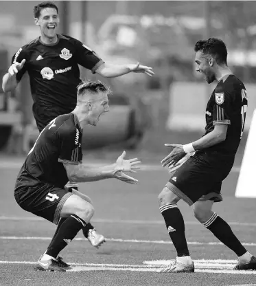  ?? JOHN LUCAS/ EDMONTON JOURNAL/ FILE ?? FC Edmonton’s Shaun Saiko, right, celebrates with teammates after scoring against Minnesota United FC during NASL action at Clarke Field during the spring season.