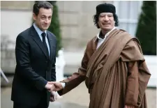  ??  ?? Then French president Nicolas Sarkozy, left, greets Libyan leader Muammar Gaddafi in 2007. Photo: AP