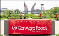  ?? NATI HARNIK / AP FILE ?? Flags fly over ConAgra Foods’ world headquarte­rs in Omaha, Neb. The company will pay a record $11.2 million fine in the tainted peanut butter case.