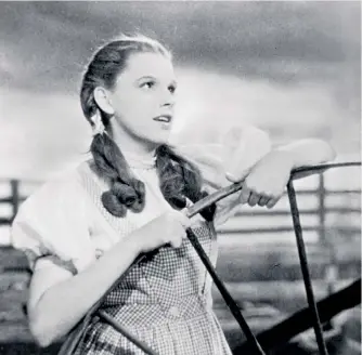  ??  ?? Mesmeric: Judy Garland as Dorothy in The Wizard of Oz, and a poster for the film, below right