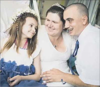  ??  ?? Kayleigh Walsh with parents Paul and Lyndsey, who married while Kayleigh is receiving treatment for neuroblast­oma. HAPPY FAMILY: