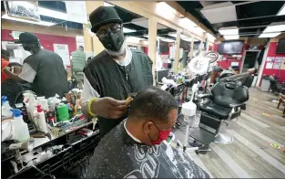  ?? JULIO CORTEZ — THE ASSOCIATED PRESS ?? Wallace Wilson cuts the hair of James McRae last Friday in Hyattsvill­e, Md. Wilson is a member of the Health Advocates In Reach & Research program, which helps barbers and hair stylists to talk to people about health.