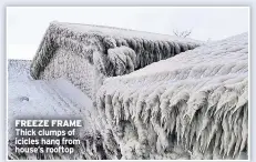  ??  ?? FREEZE FRAME
Thick clumps of icicles hang from house’s rooftop