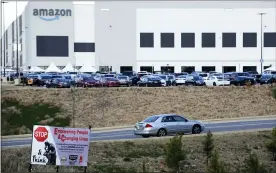  ?? JAY REEVES — THE ASSOCIATED PRESS FILE ?? The Amazon facility in Bessemer, Ala., where organizers are pushing for some 6,000 workers to join the Retail, Wholesale and Department Store Union on the promise it will lead to better working conditions, better pay and more respect. Amazon is pushing back, arguing that it already offers more than twice the minimum wage in Alabama and workers get such benefits as health care, vision and dental insurance without paying union dues.