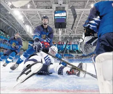  ?? Grigory Dukor Associated Press ?? MIRA JALOSUO of Finland checks Haley Skarupa of the U.S. during the preliminar­y round of women’s hockey at the 2018 Winter Olympics in Gangneung, South Korea.