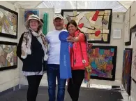  ??  ?? At the 2018 Hot Works Estero Fine Art Show , winning fiber artist K evin Kichar celebrates with Marianne Mege la, artist judge ( left), and P atty Narozny, the event’s executive producer .