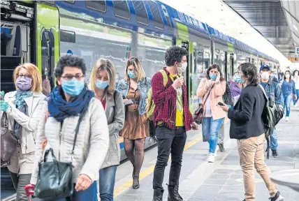  ?? AFP ?? Commuters arrive from regional trains at the Cardona railway station in Milan, Italy yesterday as the country began to ease its lockdown.