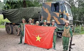  ?? THE KOKANG ONLINE MEDIA VIA AP ?? Members of the Myanmar National Democratic Alliance Army pose with a captured truck in Myanmar’s Shan state.