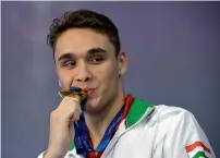  ?? AFP ?? Gold medallist Hungary’s Kristof Milak poses on the podium after winning the men’s 200m butterfly swimming final. —