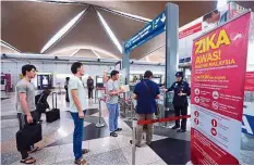  ??  ?? Travelling safely: A bunting at KLIA’s departure hall urging Malaysians going abroad to countries affected by Zika virus to take precaution­s.