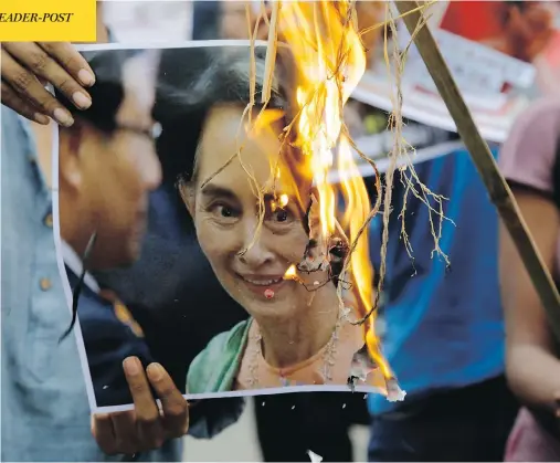  ?? BIKAS DAS / THE ASSOCIATED PRESS ?? Activists burn a photo of Myanmar leader Aung San Suu Kyi during a protest against the killings of Rohingya Muslims in Kolkata, India, Monday.