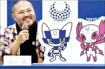  ?? TORU YAMANAKA/AFP ?? Ryo Taniguchi, winning designer of the official mascots for the 2020 Olympic (left) and Paralympic Games, answers questions during a press conference at an elementary school in Tokyo yesterday.