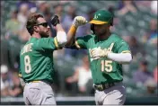  ?? PAUL SANCYA — THE ASSOCIATED PRESS ?? The A's Seth Brown (15) celebrates his two-run home run with Jed Lowrie (8) against the Tigers in the eighth inning on Thursday in Detroit.