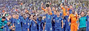  ?? —
AP ?? The Chelsea players celebrate after their Club World Cup final match against Brazilian Club Palmeiras in Abu Dhabi on Sunday. Goals from Romelu Lukaku and Kai Havertz secured a 2-1 win as well the trophy for Chelsea.
