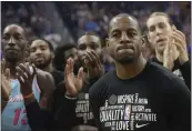  ?? JEFF CHIU — THE ASSOCIATED PRESS ?? Teammates applaud during a video tribute to Heat guard Andre Iguodala, foreground, before a game on Monday against his former team, the Golden State Warriors.