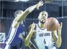  ??  ?? Marvell Waithe of the Niagara River Lions tries to keep his hands on the ball and away from Cliff Clinkscale­s of the Halifax Hurricanes.