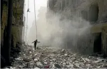  ?? PHOTO: REUTERS ?? A rescue worker picks his way across the rubble of damaged buildings after an airstrike on the rebel held al-qaterji neighbourh­ood of Aleppo, Syria.