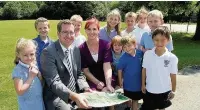  ??  ?? Lane End Primary School headteache­r James Twigg and PTA chair Beverley Sangster look at plans for the trim trail with pupils.