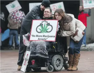  ?? TONY CALDWELL ?? Cannabis activists Sherry Morrison, centre, and her kids Taryn Morrison and Tasha Lee Selden protest raids on pot shops at the courthouse in Ottawa on Wednesday. Morrison’s daughter, Cassandra, was arrested at the Weeds shop on Bank Street on Jan. 31...