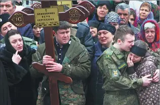  ?? MUSA SADULAYEV / ASSOCIATED PRESS ?? Family and friends of victims of the deadly attack on churchgoer­s in Russia’s predominan­tly Muslim Dagestan region, mourn at a funeral service in Kizlyar, Russia, on Tuesday. At least five people were killed and four wounded when a gunman opened fire...