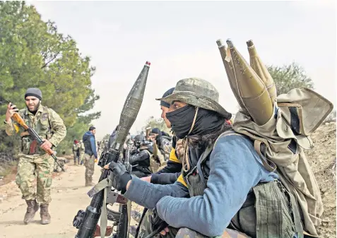  ??  ?? Fighters from the Free Syrian Army, backed by the Turkish army, prepare to launch an operation against Kurdish forces in Afrin yesterday as part of Operation Olive Branch