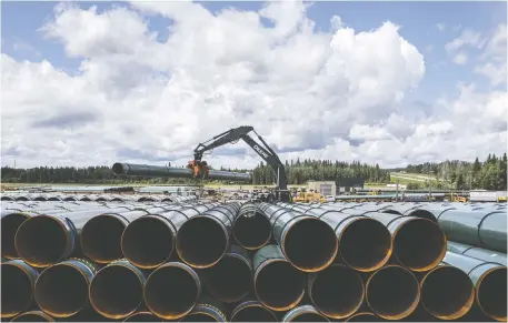  ?? JASON FRaNSON/THE CANADIAN PRESS ?? There are signs that the pipeline industry is turning around, including major court wins green-lighting the Trans Mountain expansion in Canada, as well as the Line 3 and Keystone XL pipelines in the U.S. Above, pipe for Trans Mountain is unloaded in Edson, Alta.