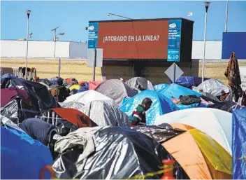  ?? ALEJANDRO TAMAYO U-T ?? Asylum seekers camp out near a port of entry in Tijuana. The Biden administra­tion says the situation at the southern border played a role its decision-making process regarding whether to increase limits on refugees.