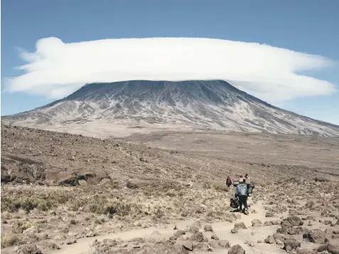  ??  ?? PEAK PRACTISED: Porters heading towards the summit of Mount Kilimanjar­o, the dormant Tanzanian volcano that is Africa’s highest mountain.