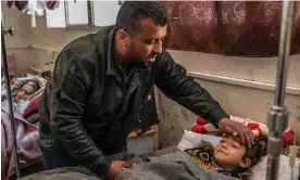  ?? Photograph: Alessio Mamo/The Guardian ?? Omar Rahal with his cousin’s daughter Jinan at a makeshift hospital.