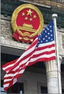  ?? DOUG MILLS / NEW YORK TIMES 2017 ?? The U.S. flag flies outside the Great Hall of the People in Beijing during a welcome ceremony in November for President Donald Trump. Both China and the U.S. are imposing tariffs on each other.