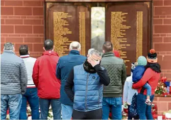  ?? — AFP ?? Not forgotten: Mourners gather atthe Hillsborou­gh memorial outside of Anfield in Liverpool on Monday.