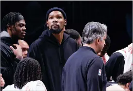  ?? COREY SIPKIN — THE ASSOCIATED PRESS ?? Brooklyn Nets forward Kevin Durant, center, looks on from the bench during a game against the Los Angeles Lakers, Jan. 30, in New York.