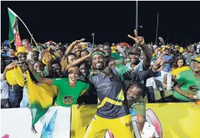  ?? FILE ?? Chris Gayle (centre) of the Jamaica Tallawahs celebratin­g with fans at the end of Match 34 of the Hero Caribbean Premier League final at Warner Park in Basseterre, St Kitts, last year.