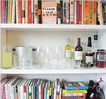  ??  ?? A temporary bar for a party, set up in a bookcase. Making the most of different areas of your home is very helpful when you have a big group over.