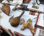  ?? PAUL POST — PPOST@DIGITALFIR­STMEDIA.COM ?? Historical artifacts such as a 17th-century pistol and gunpowder flasks are displayed.