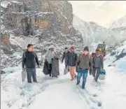  ?? ?? EC officials with EVMS on their way to polling stations in Himachal Pradesh’s Lahaul and Spiti district on Thursday.