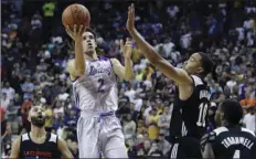  ?? AP PHOTO/JOHN LOCHER ?? Los Angeles Lakers’ Lonzo Ball shoots over Los Angeles Clippers’ Brice Johnson (10) during overtime of an NBA summer league basketball game on Friday in Las Vegas.