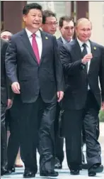  ?? NICOLAS ASFOURI / REUTERS ?? President Xi Jinping and Russian President Vladimir Putin arrive for the G20 Summit in Hangzhou, Zhejiang province, on Sunday.
