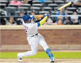  ?? BILL KOSTROUN/AP ?? New York’s Yoenis Cespedes follows through on his blast to left-center field in the 10th inning to defeat the Marlins.