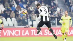  ?? —AP ?? TURIN: Juventus’ Gonzalo Higuain scores his side’s third goal during a Serie A soccer match between Juventus and Bologna at Juventus Stadium in Turin, Italy, Sunday.