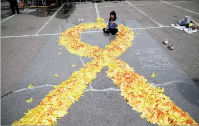  ?? PHOTO: REUTERS ?? A girl sits inside a large yellow ribbon dedicated to victims of the sunken Sewol ferry disaster that killed 304 people, mostly schoolchil­dren, during a ceremony to commemorat­e its 10th anniversar­y in Ansan, South Korea, yesterday.