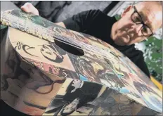  ?? PICTURES: BRUCE ROLLINSON ?? JOHNNY B GOODE: Artist Johnny Young with some of his art and guitar art decorated to celebrate Prince, Jim Hendrix and Salvador Dali. ‘The guitars I make are not to use,’ he said. ’I make my own guitars from scratch.’