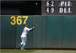  ?? JEFF CHIU — THE ASSOCIATED PRESS ?? A’s left fielder Chad Pinder catches a fly out hit by the Rays’ Brandon Lowe during the sixth inning on Wednesday.