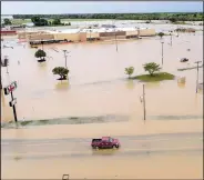  ?? Arkansas Democrat-Gazette/STEPHEN B. THORNTON ?? A truck travels on U.S. 67 in east Pocahontas on Wednesday after the Black River reached a record level Tuesday night. Because of levee breaks, the water began to recede Wednesday.